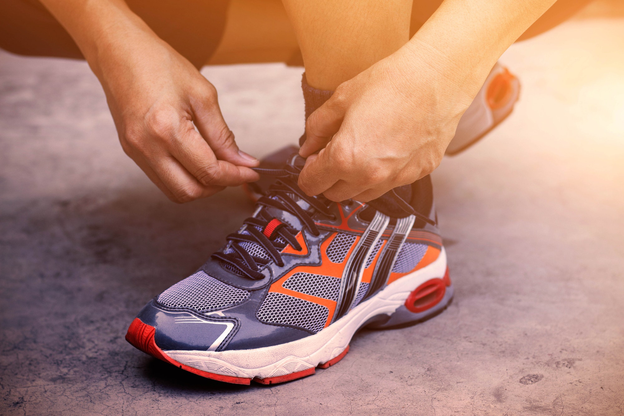 Hands tying shoes for jogging