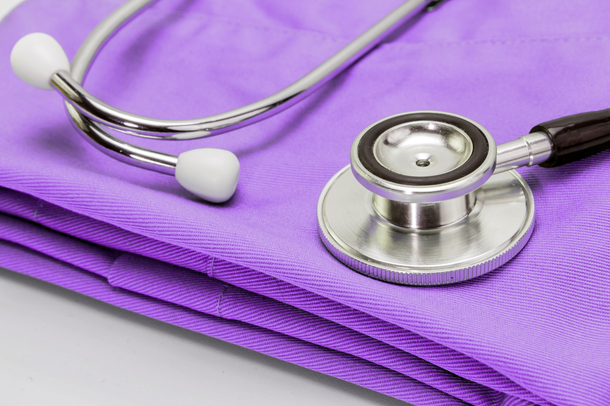 Stethoscope on clothes of nurse, conceptual image