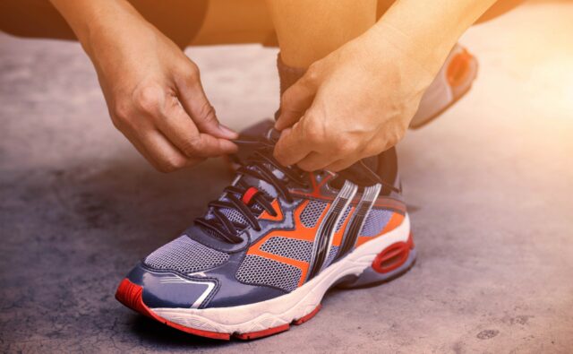 Hands tying shoes for jogging