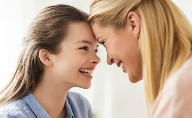 happy smiling family of girl and mother at home