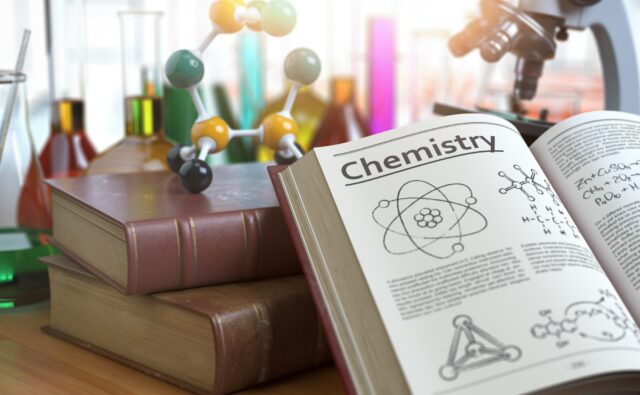 Chemistry education concept. Open books with text chemistry and